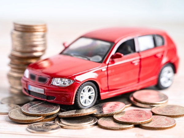Car Toy on a Stack of Coins