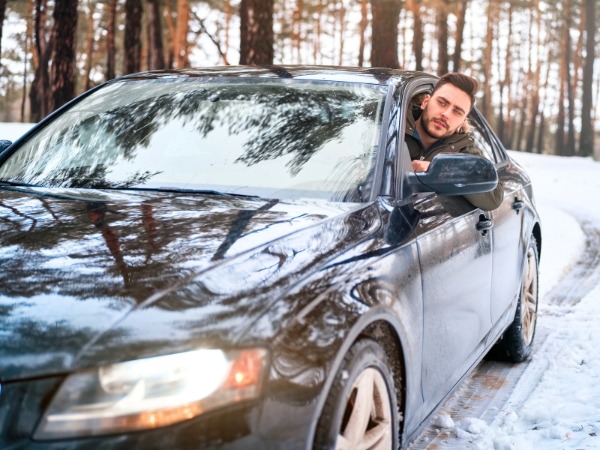 Man Driving on a Snowy Road